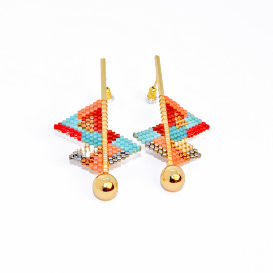 Colorful beaded earrings with gold balls on a white background
