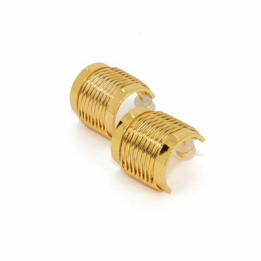 Pair of gold hoop earrings on a light gray background