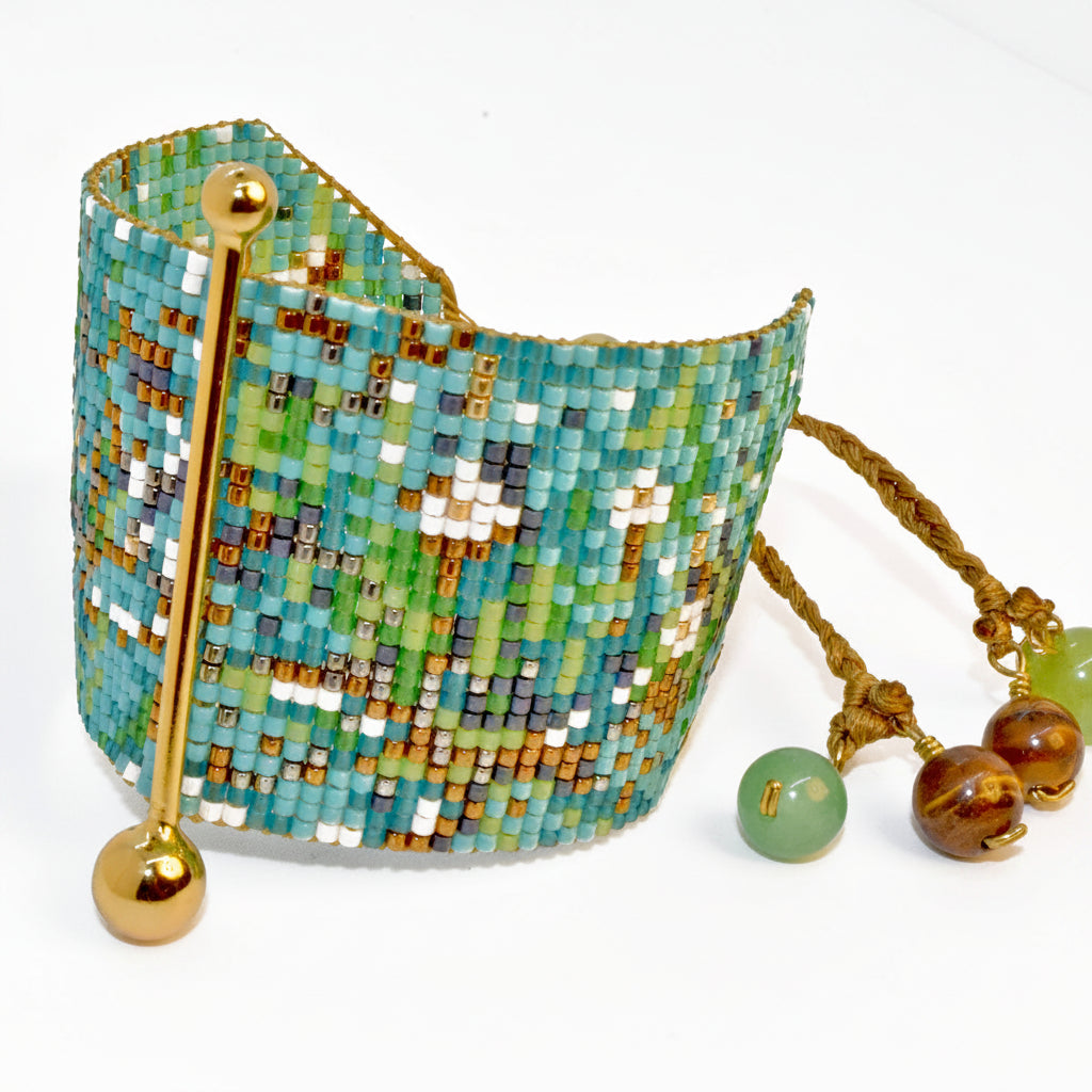 Beaded bracelet with a decorative hook and additional beads on a white background