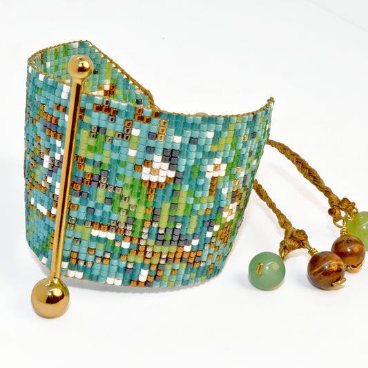 Beaded bracelet with a decorative hook and additional beads on a white background