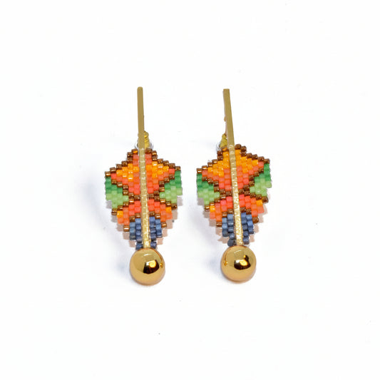 Colorful beaded earrings with gold balls on a white background
