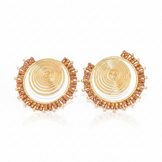 Pair of gold and brown circular earrings on a white background